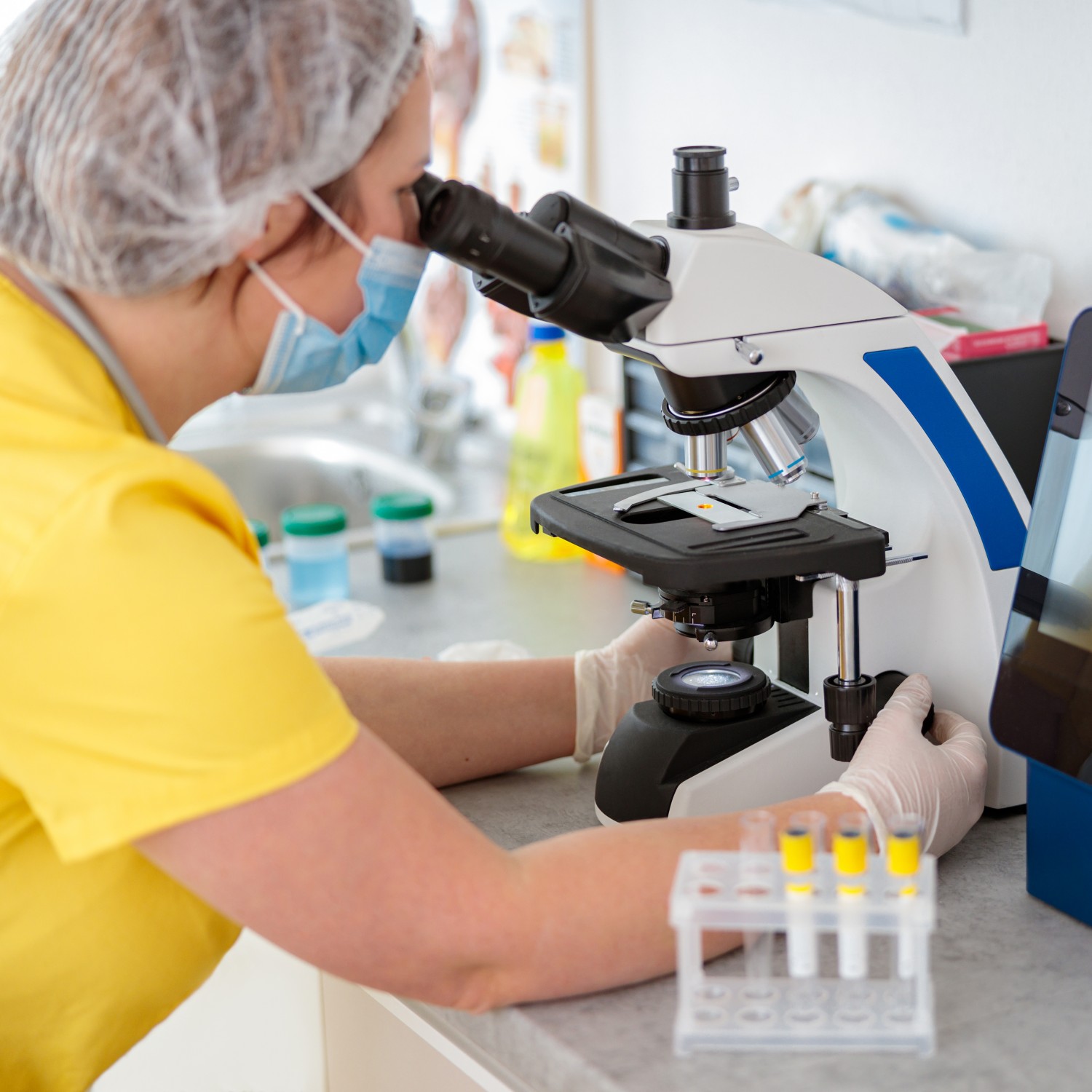 Veterinarian Looking Through a Microscope